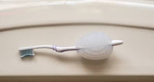 Load image into Gallery viewer, everyday tasks are easy with numuv grip aid fits toothbrush
